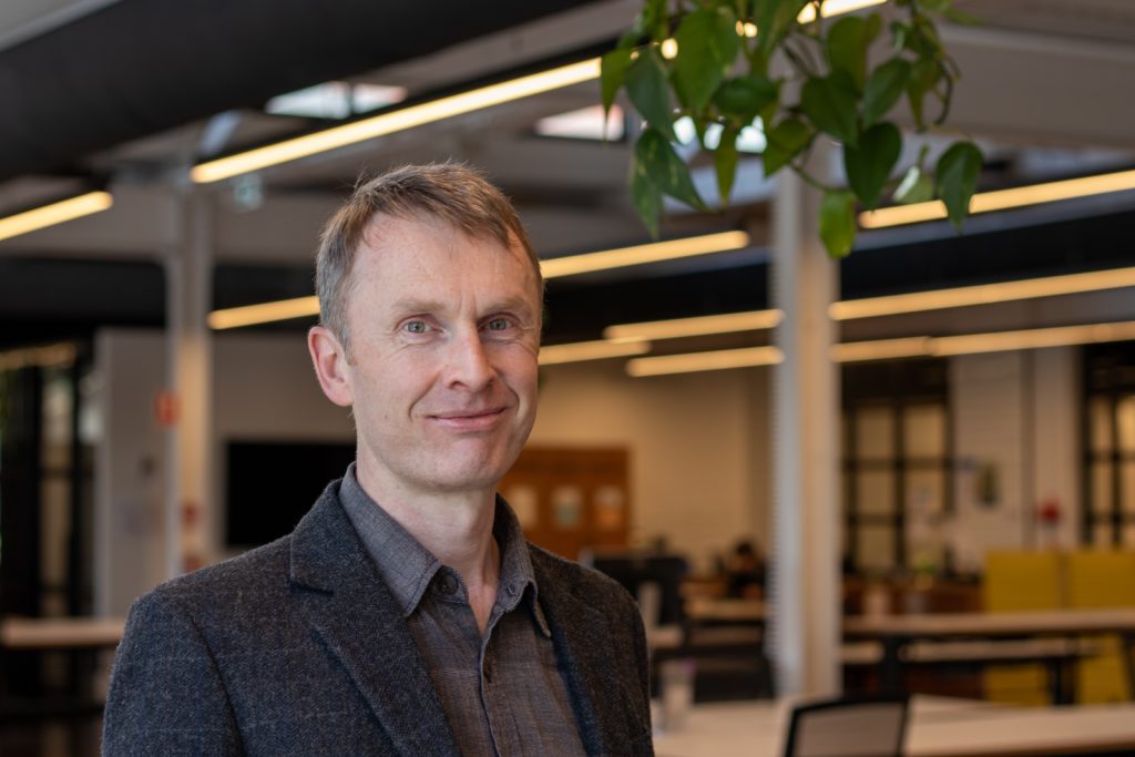 Man smiling in modern office setting