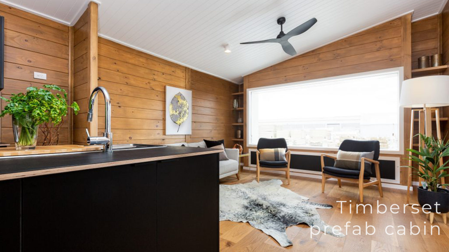 Modern timber cabin interior with kitchen and lounge